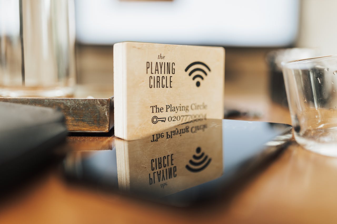 services-03 A wooden block displaying Wi-Fi details sits on a modern office desk.