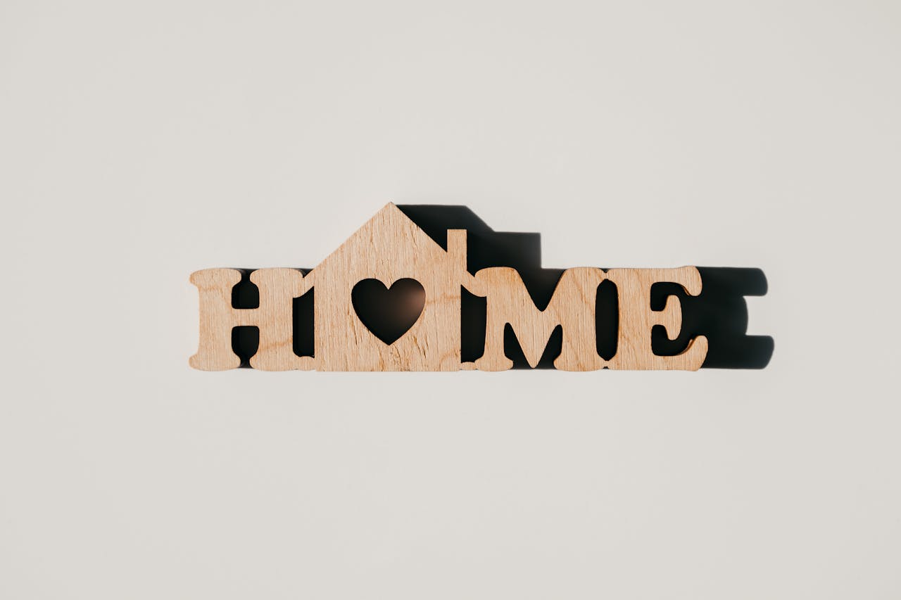 about-01 A minimalist wooden sign spelling 'HOME' with a heart-shaped cutout, perfect for decor inspiration.